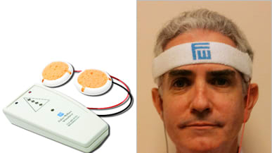 The device is shaped like an elongated deck of cards and has a pyramid on the front with four lights in the pyramid indicating the strength of the neurostimulation and two cords attached to two sponge electrodes.