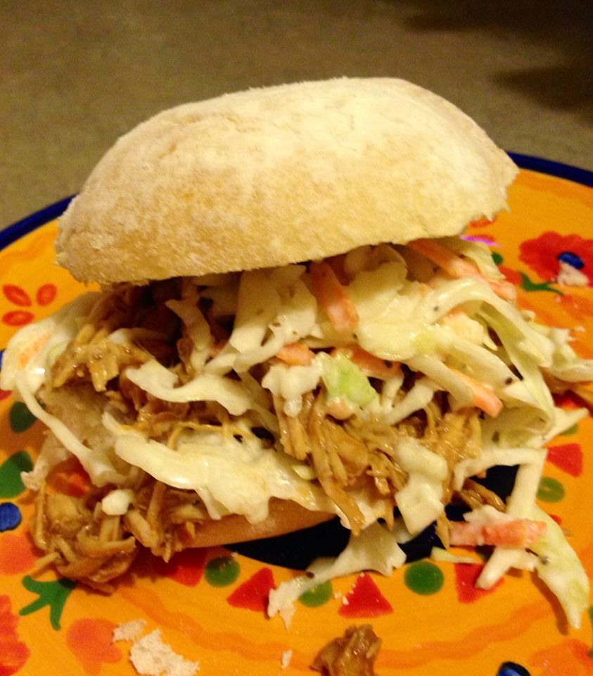Shredded BBQ chicken sandwich, topped with coleslaw