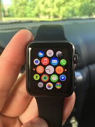 hand holding apple watch with icons of all apps on the face