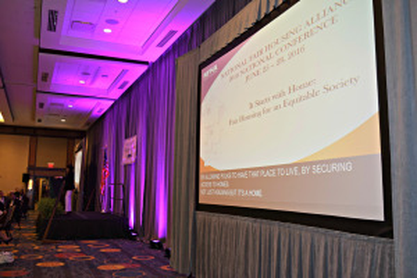 Conference Room with a large screen containing both a slide and captions