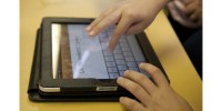 Person's hands on an iPad