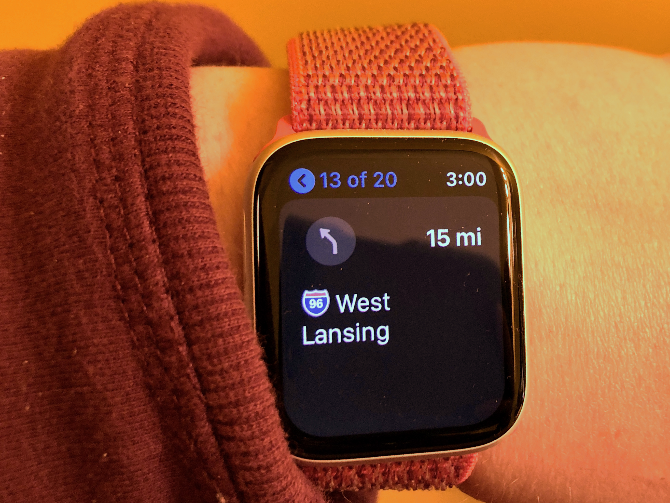 A person's wrist wearing an Apple Watch.  The watch shows turn by turn directions via the Apple Maps app.