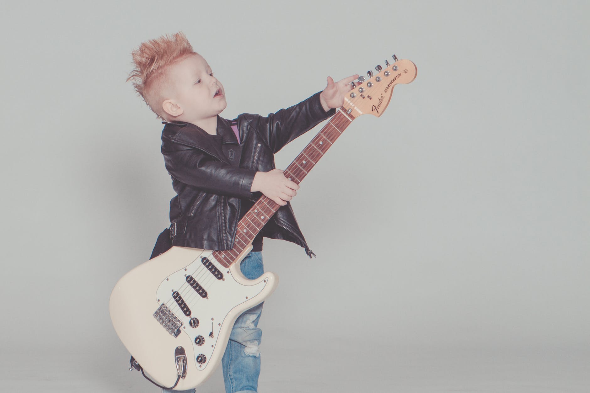 Child playing with an electric guitar.